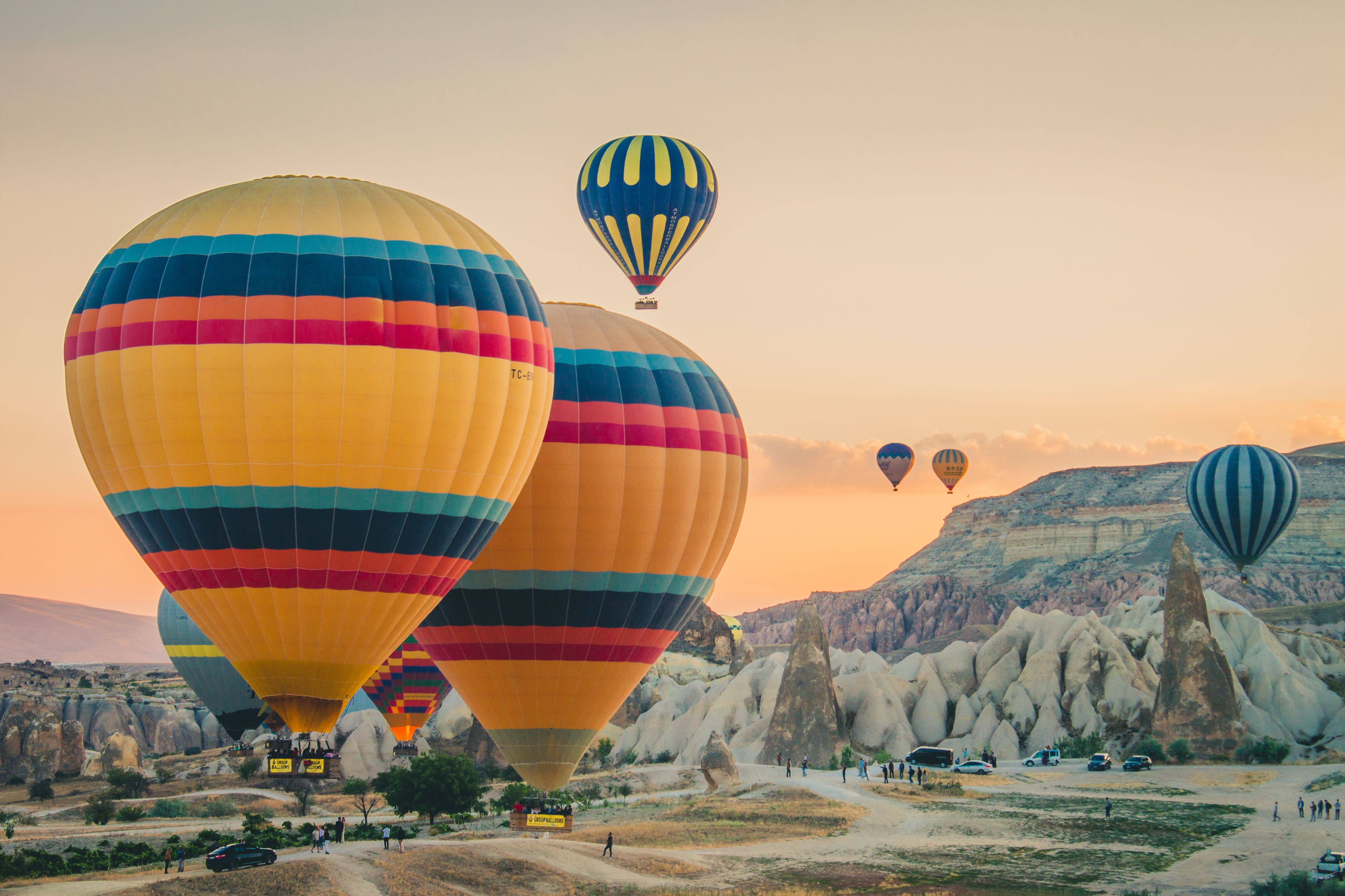 multi-colored-hot-air-balloons-flying-land.jpg