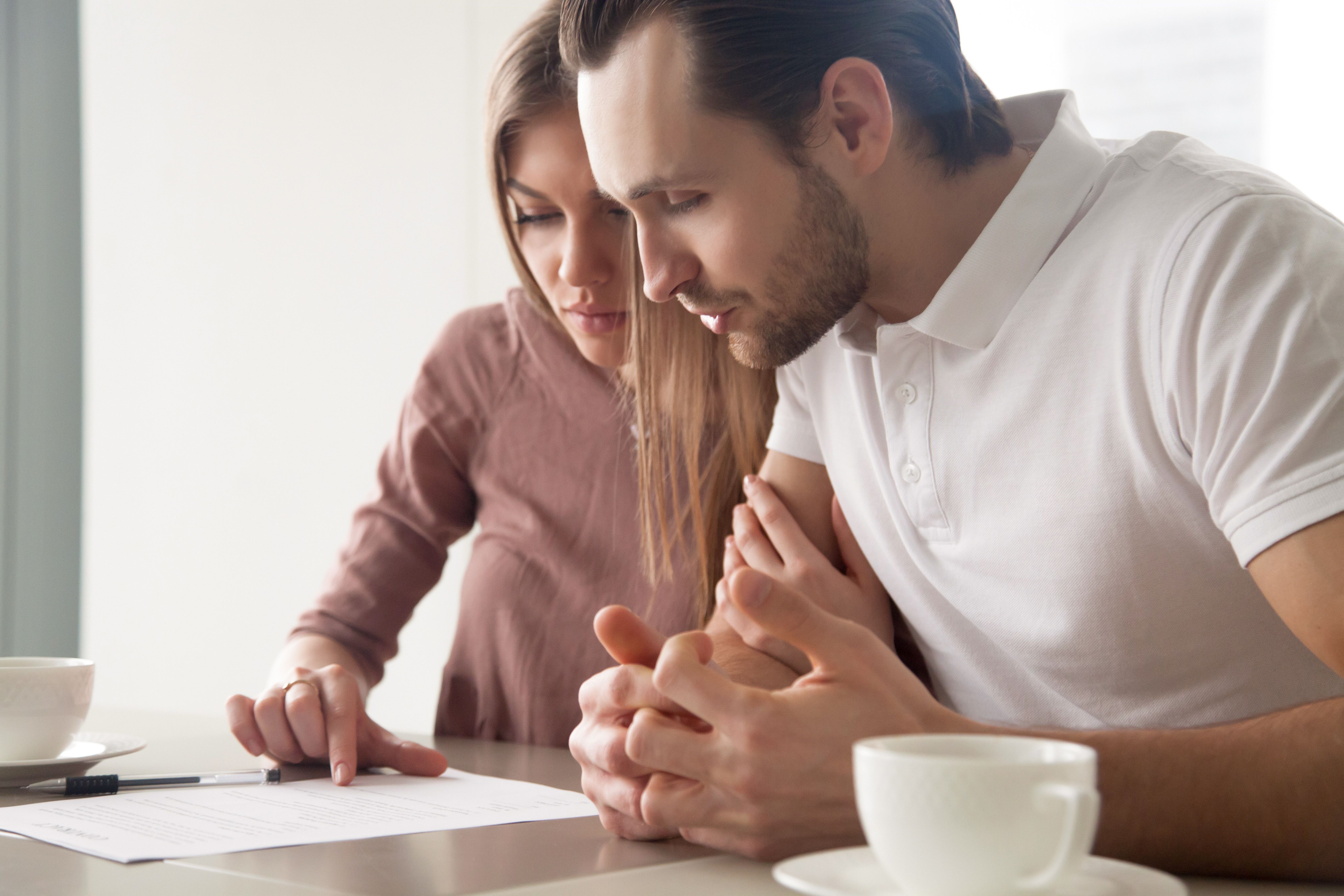 serious-couple-studying-contract-agreement-reading-terms-conditions-attentively-before-signing-husband-wife-calculating-domestic-bills-considering-mortgage-loan-offer-health-insurance.jpg