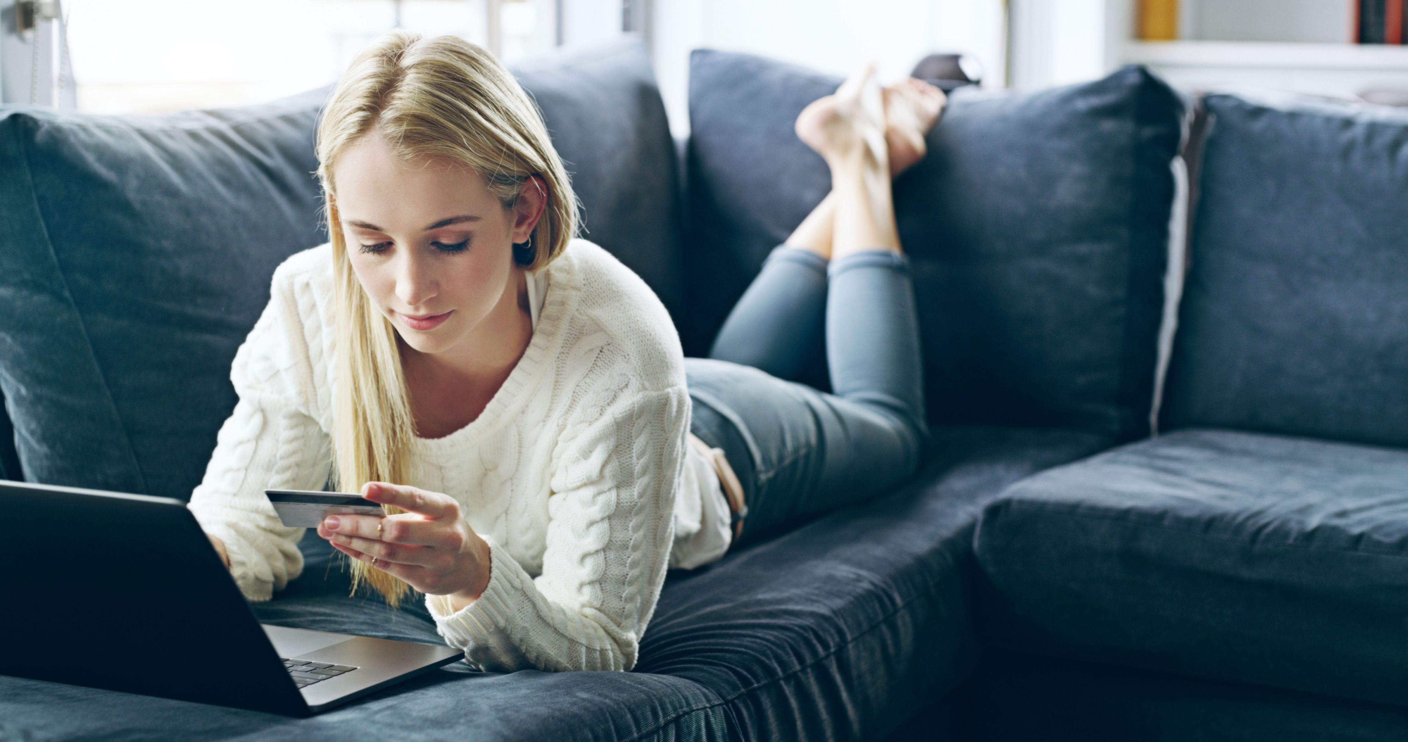 woman-laptop-credit-card-with-banking-sofa-online-shopping-ecommerce-wireless-transaction-person-shopper-paying-discount-financial-investment-payment-lounge-home.jpg