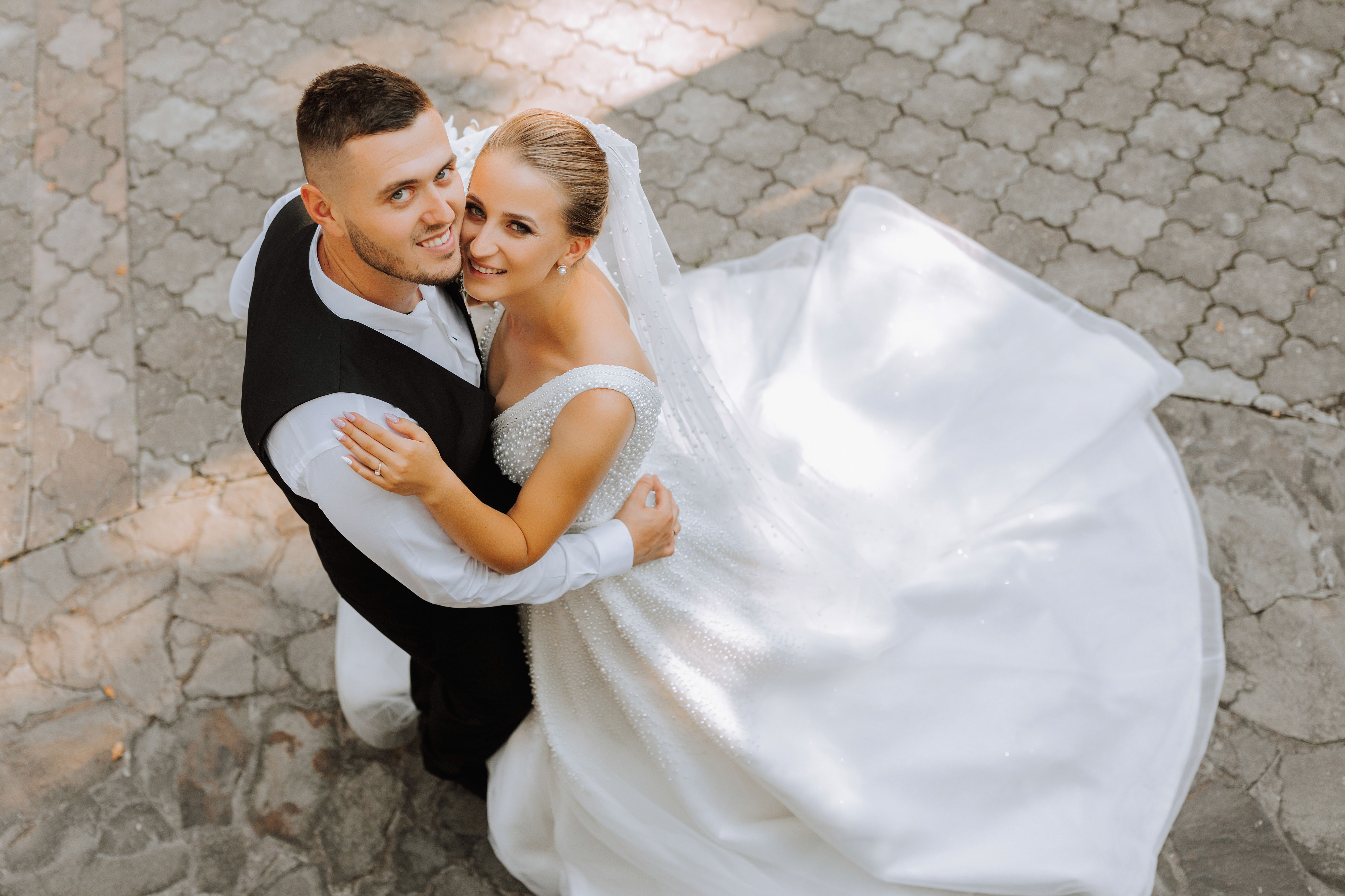 young-beautiful-wedding-couple-romantically-hugging-looking-camera-photo-taken-from.jpg